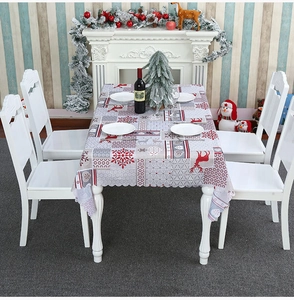 Detailed view of Christmas polyester tablecloth featuring red reindeer and snowflake patterns