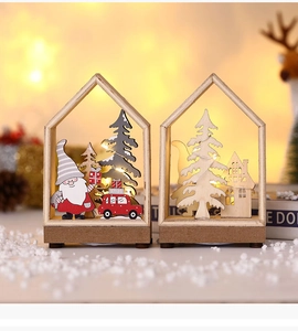 Detail of wooden LED Christmas ornaments with Santa and pine trees in warm lighting