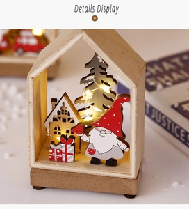 Detail display of wooden Christmas house with LED lights and Santa Claus miniature