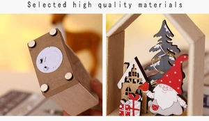 Detail view of the battery base and craftsmanship of a lighted wooden Christmas cabin ornament