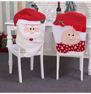 Detail of Santa Claus and Mrs. Claus chair covers with green bows for Christmas decor