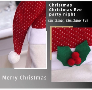 Detail of red and white knitted Christmas chair cover with faux fur trim and berry accent