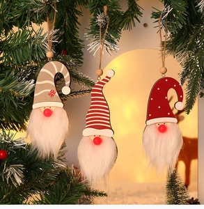 Close-up of three festive forest gnome ornaments with glowing lights on a Christmas tree