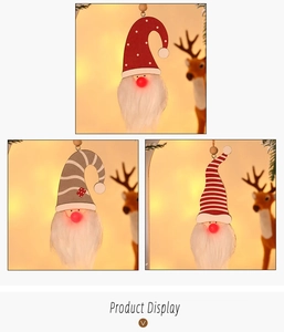 Close-up of glowing Christmas gnomes with warm LED noses and festive pattern hats