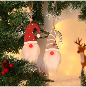 Detail of illuminated Christmas gnome hanging ornaments with red polka dots and grey stripes