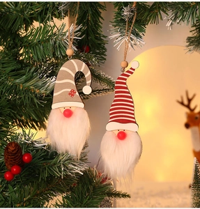 Close-up of glowing forest gnome ornaments hanging on a Christmas tree with pine cones