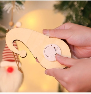 Detail of wooden Christmas forest gnome pendant with warm light battery compartment