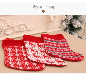 Close-up of three knitted Christmas stockings with Nordic snowflake and reindeer patterns