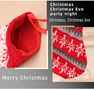 Detail of red and white knitted Christmas stocking showing texture and snowflake pattern