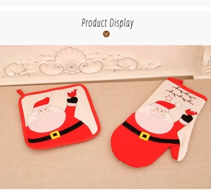 Christmas oven mitt and pot holder set with Santa Claus pattern on textured table