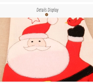 Detail display of Santa Claus embroidery on ivory woven Christmas glove fabric