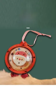 Detail of DIY wooden Christmas ornament with Santa illustration and plaid ribbon
