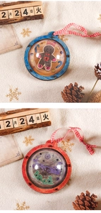 Close-up of DIY wooden Christmas ball pendants with gingerbread man and sleigh designs
