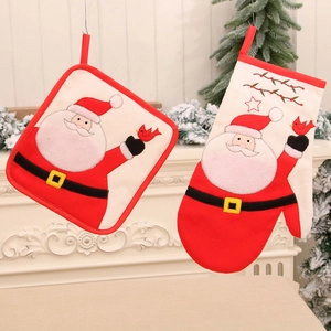 Christmas oven mitt and pot holder set featuring Santa Claus on a white fireplace mantle