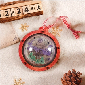 DIY wooden Christmas ball ornament with Santa silhouette and red checkered ribbon