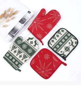 Detailed view of Christmas oven mitts and pot holders with festive snowflake and reindeer prints