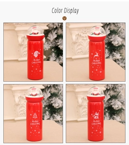 Detail of red Christmas insulated mugs with Santa snow globe lids and festive prints