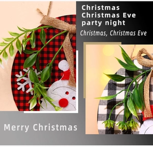 Detail of Christmas wooden door signs with plaid fabric and Santa Claus felt decoration