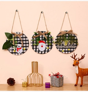 Detail of three round wooden Christmas signs with rustic plaid fabric and 3D Merry Christmas text