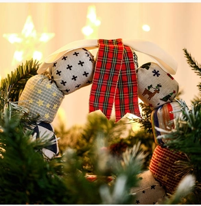 Close-up of a Christmas fabric wreath with elk patterns and festive plaid ribbon bow