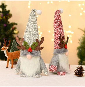 Close-up of Christmas gnomes with glittery reindeer antlers and festive pine cone decor
