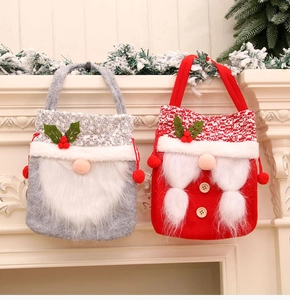 Detail of Christmas gnome felt gift bags with white faux fur trim and pompom drawstring