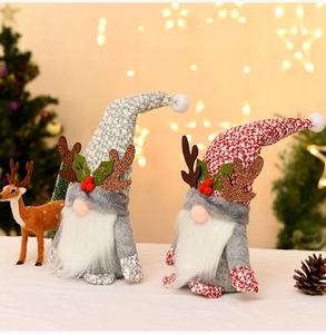 Close-up of plush Christmas gnomes with reindeer antlers and festive knitted hats