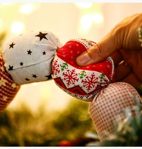 Macro detail of fabric candy Christmas ornaments with festive embroidery and textures