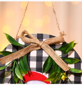 Macro shot of rustic Christmas wreath featuring buffalo plaid and festive greenery details
