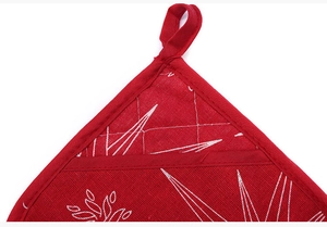 Detail of red Christmas heat insulation pad with white star patterns and hanging loop