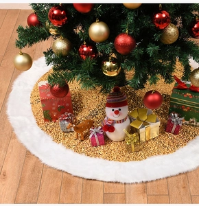 Festive Christmas tree skirt with gold sequins and white faux fur trim on wooden floor