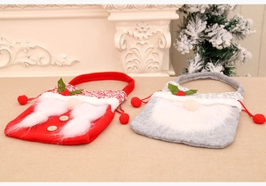 Detail of Christmas gnome drawstring gift bags with plush beards and knit trim accents