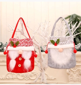 Detail of Christmas gnome apple bags in red and grey felt with soft faux fur beard