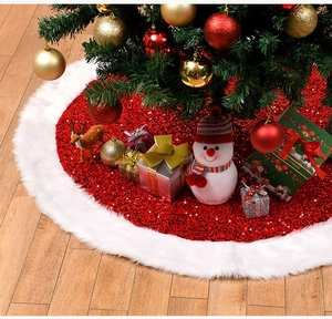 Detail of red sequined Christmas tree skirt with plush white faux fur trim in a cozy room