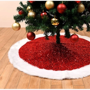 Detail of red sequined Christmas tree skirt with white faux fur trim on wood floor