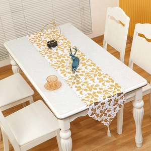 White Christmas table runner with gold leaf prints, scalloped edges and tassels
