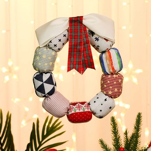 Christmas fabric wreath with colorful patterns and bow for festive door decoration