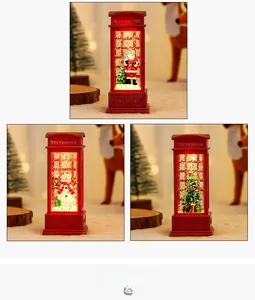 Close-up of lighted Christmas telephone booth lantern with Santa and glitter snow