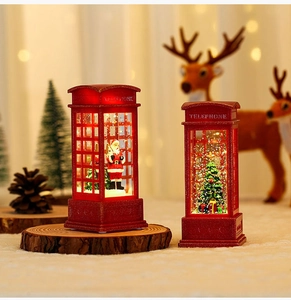 Close-up of red Christmas telephone booth lamp with Santa Claus and sparkling glitter light
