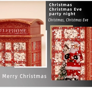 Detail of red Christmas telephone booth lamp with Santa Claus and glitter snowflakes
