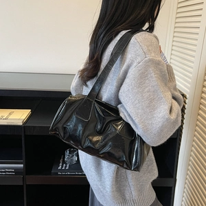 Chic black glossy leather baguette tote bag with retro pleated texture and shoulder strap