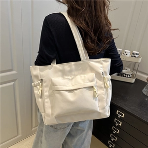 Minimalist beige large capacity tote bag with front zipper pocket and drawstring details