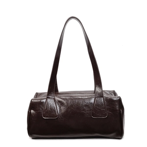 Glossy dark brown pleated baguette shoulder bag with minimalist retro aesthetic on white background