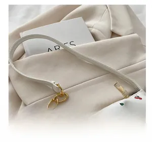 Detail of white PU leather shoulder bag with cherry print and golden chain handle