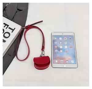 Size comparison of a red mini PU leather shoulder bag next to a tablet device