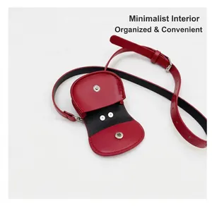 Internal view of a red leather mini waist bag with dual silver magnetic snap buttons