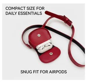 Detailed view of mini red leather waist bag storing wireless earphones with silver clasp