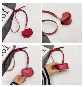 Detailed views of a mini red leather crossbody bag with silver hardware and slim strap