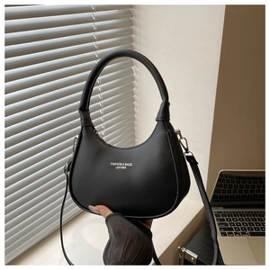 Detail of black PU leather half-moon bag with white logo and removable strap