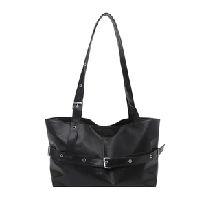 Modern black leather tote bag with silver metal eyelets and decorative buckle straps